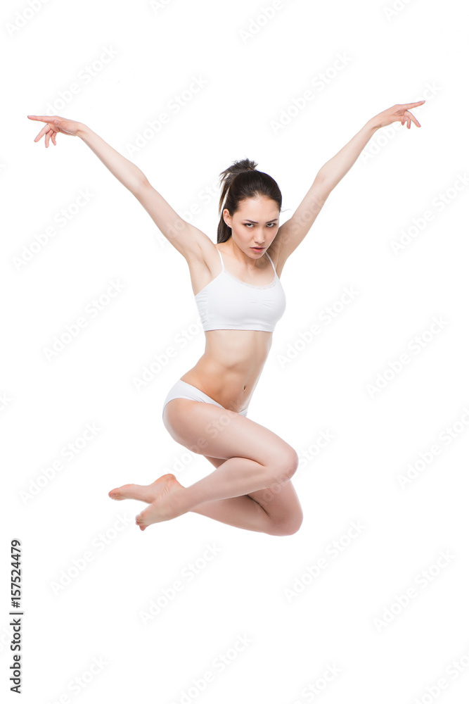 asian woman in lingerie jumping with arms up isolated on white