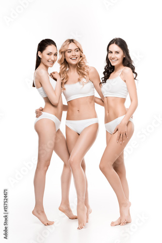 group of happy young women in lingerie posing isolated on white