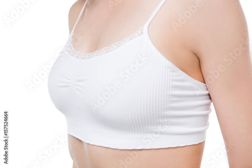 Close-up partial view of slim young woman in white underwear