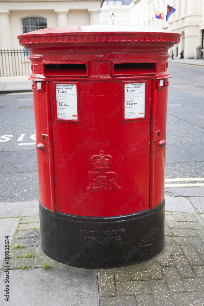 large double red letterbox on pavement in london large double red letterbox on pavement in london