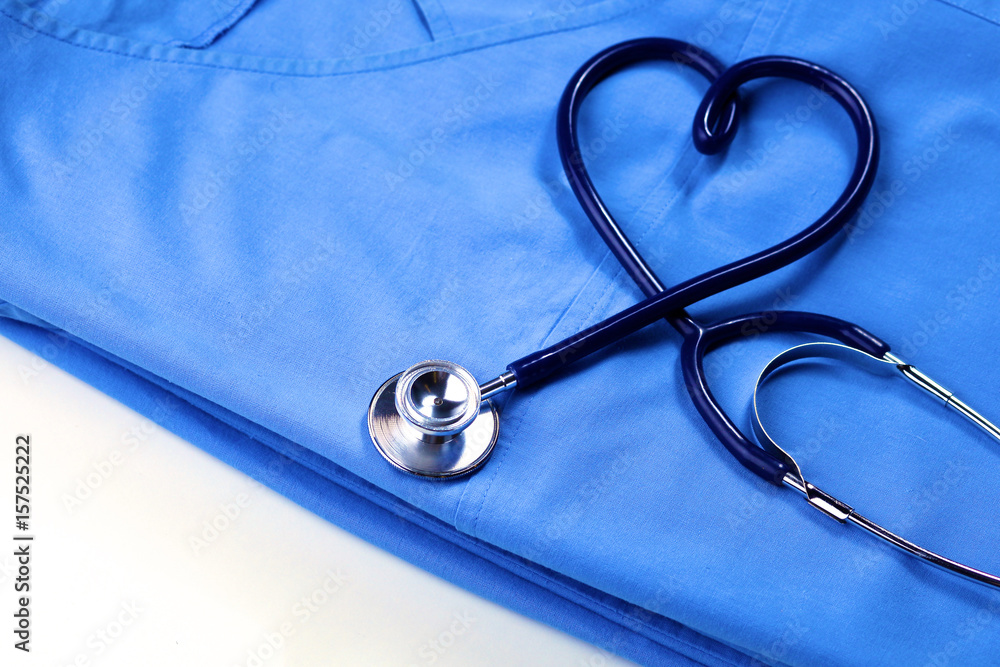 Φωτογραφία Medical stethoscope twisted in heart shape lying on patient medical history list