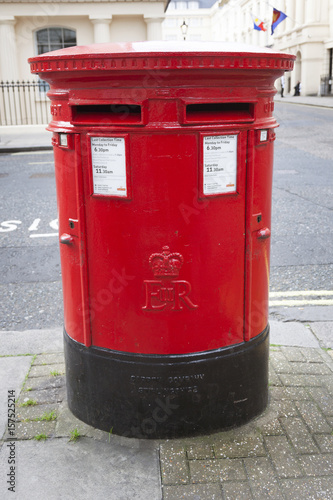 large double red letterbox on pavement in london