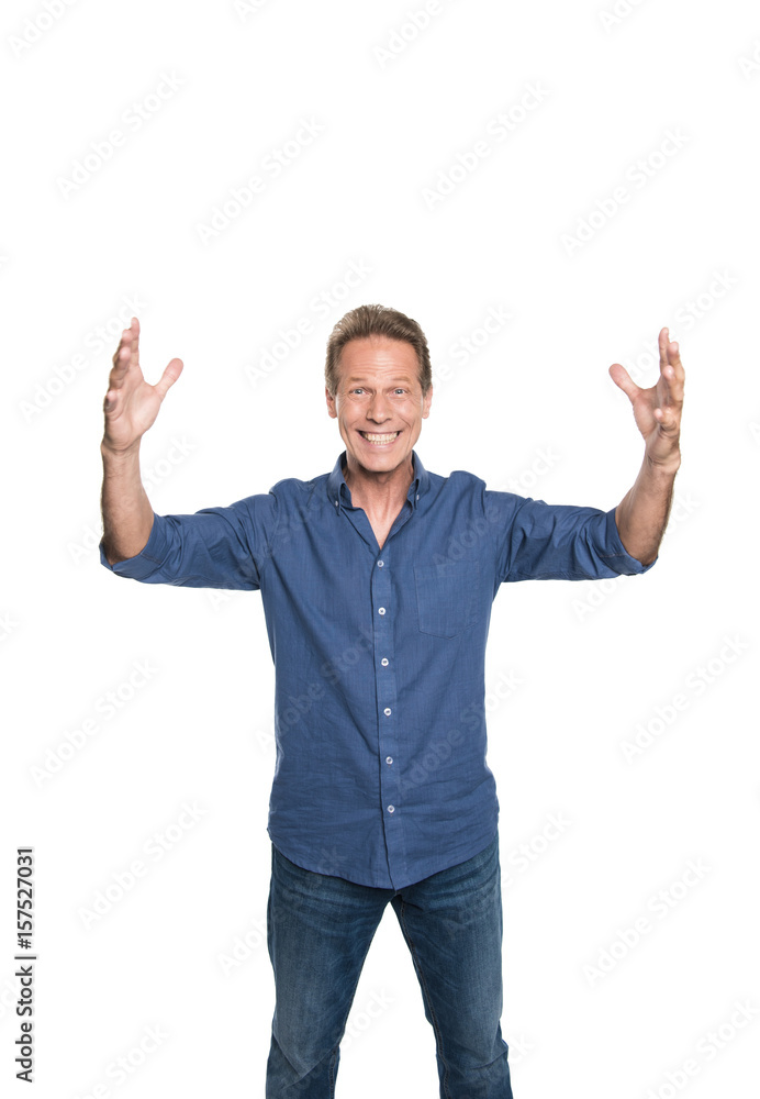 Cheerful middle aged man with open hands and looking at camera isolated on white Cheerful middle aged man with open hands and looking at camera isolated on white
