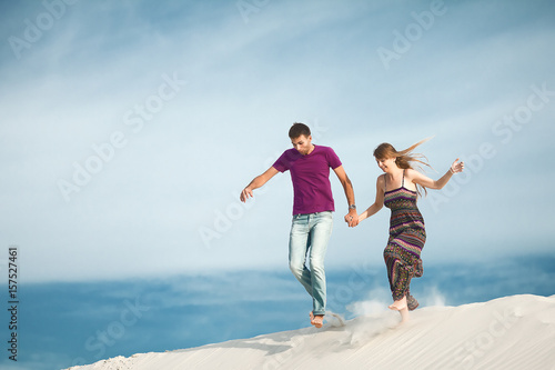 Young couple running from mountain