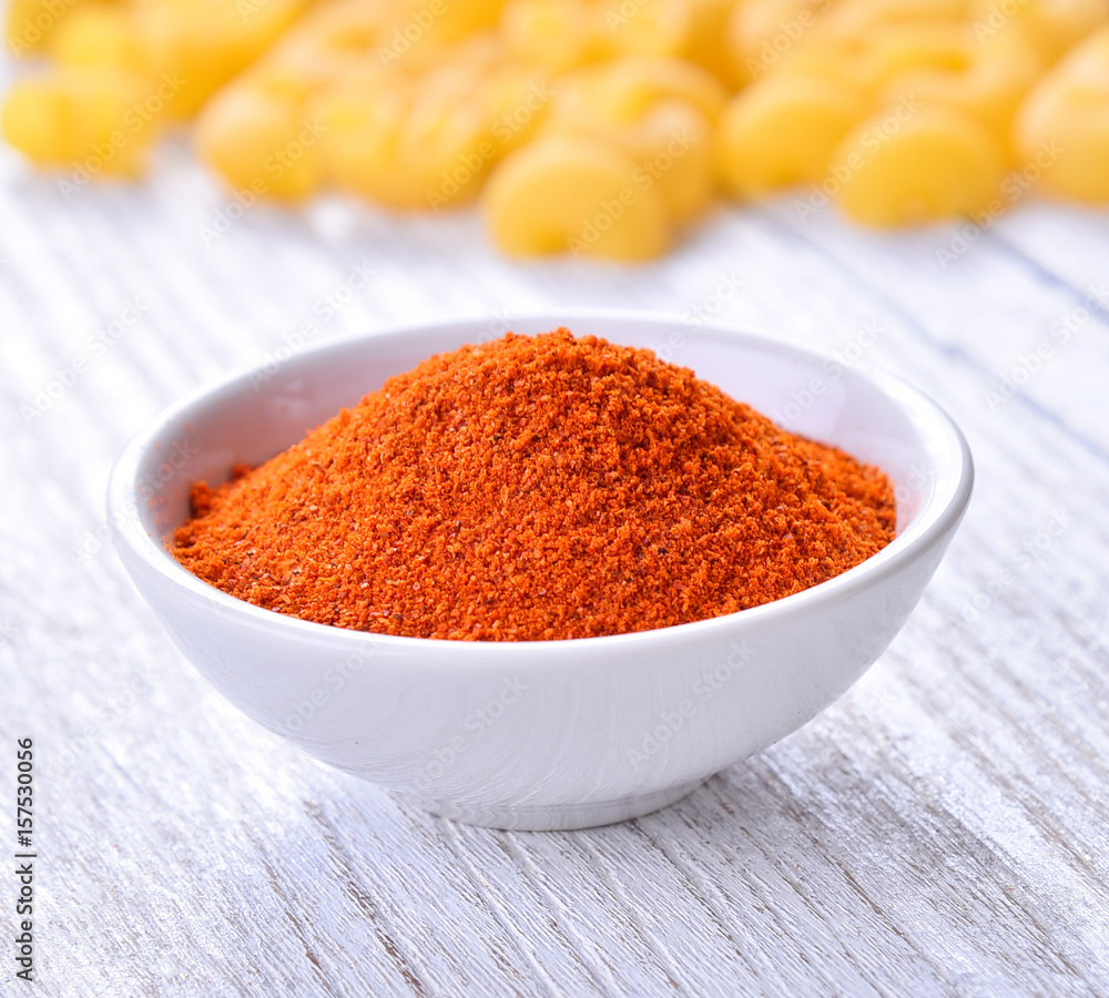 Paprika powder in white bowl on table wooden Paprika powder in white bowl on table wooden