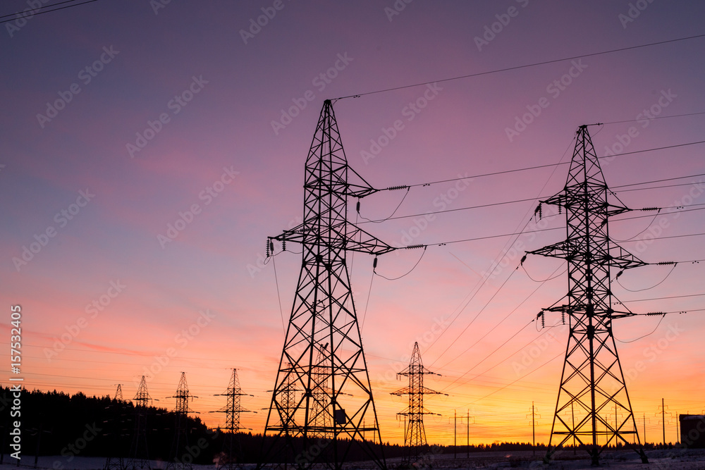 silhouettes of power lines, the theme of ecology. silhouettes on the sunset sky. Power pylons.