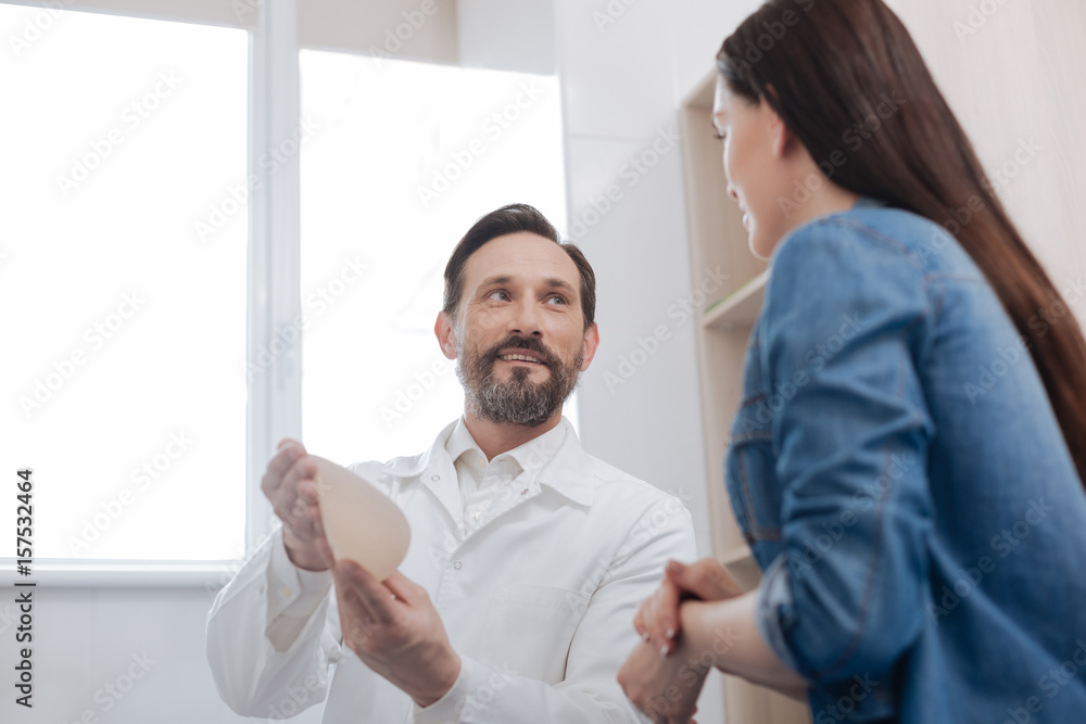 Obraz premium Private plastic surgeon showing the materials he working with