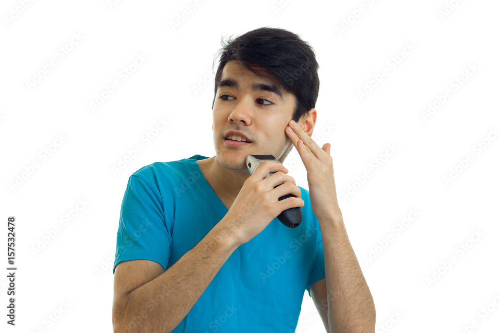 handsome young guy with black hair shaves his beard and looks toward isolated on a white background handsome young guy with black hair shaves his beard and looks toward isolated on a white background
