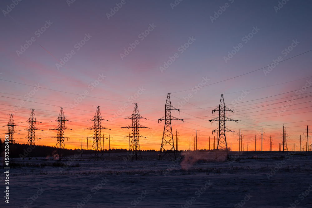 silhouettes of power lines, the theme of ecology. silhouettes on the sunset sky. Power pylons.