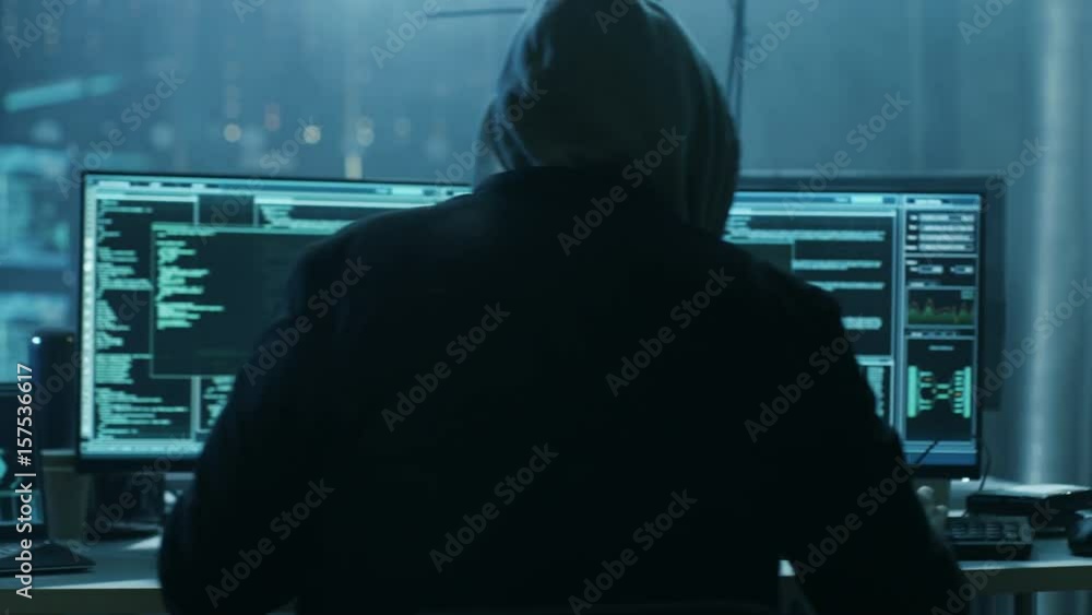 Dangerous Hooded Hacker Breaks into Government Data Servers and Infects Their System with a Virus. Shot on RED EPIC-W 8K Helium Cinema Camera.