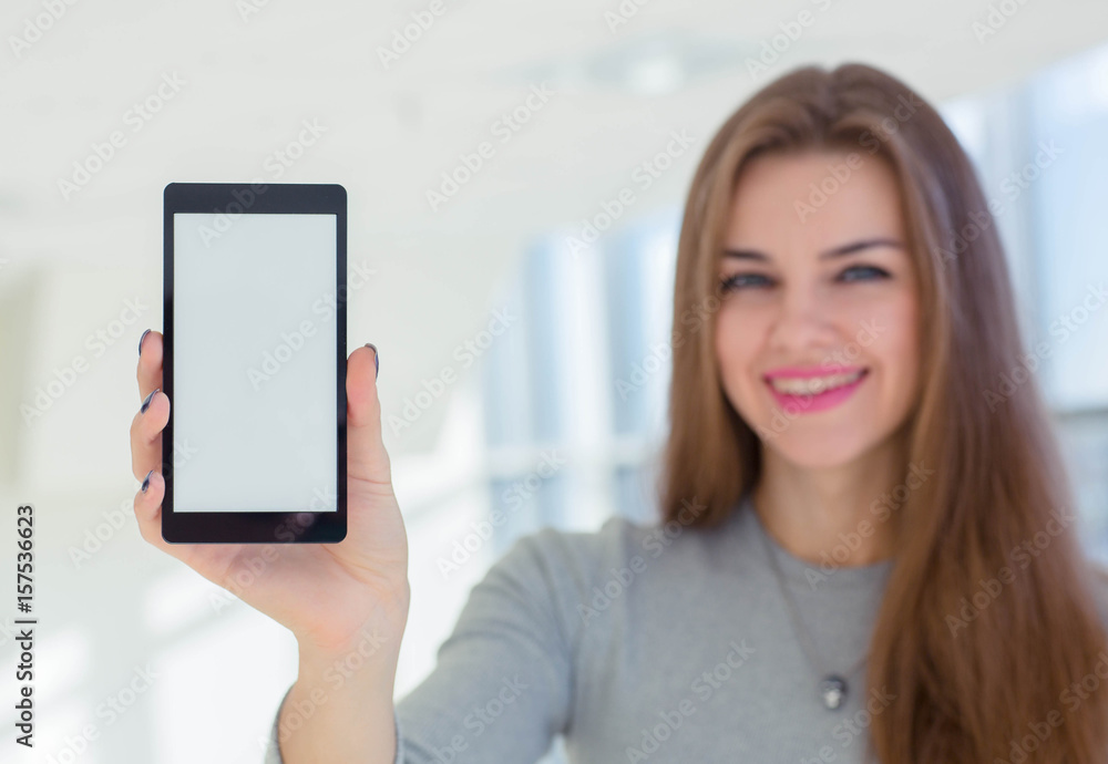 Business woman demonstrating smartphone display to camera