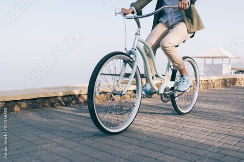 Slika na platnu woman is riding a beautiful bicycle along the sea