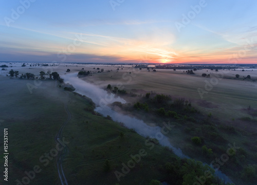 aerial view of river at sunrise  fly over morning mist on the river
