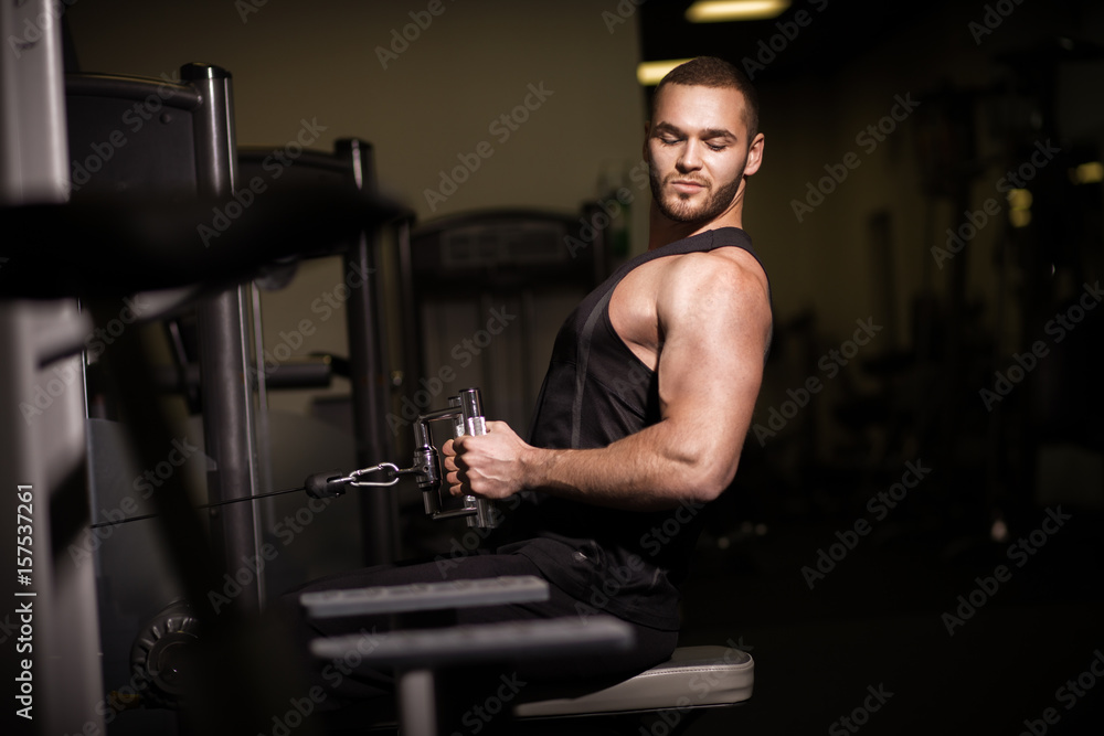 Sporty sexy men with great abdominal muscles in black sportswear Sporty sexy men with great abdominal muscles in black sportswear