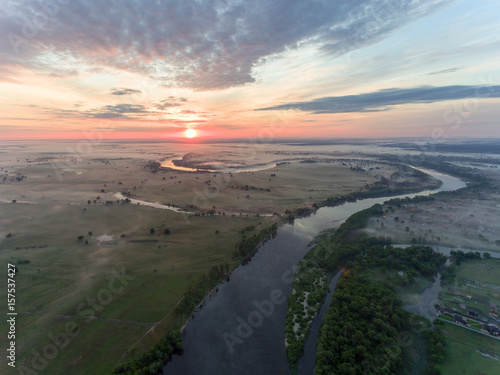 aerial view of river at sunrise, fly over morning mist on the river