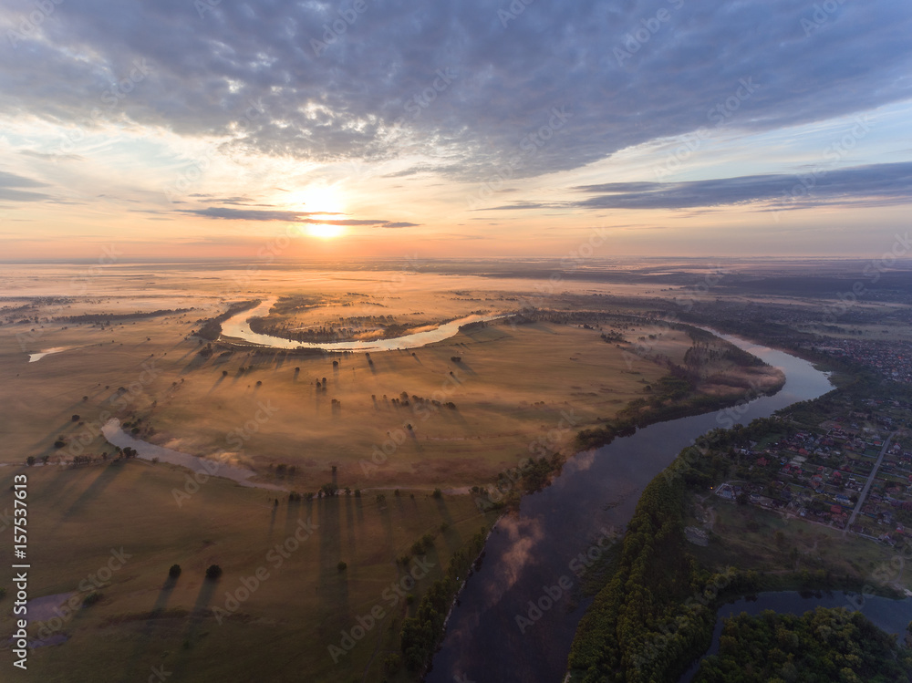 aerial view of river at sunrise, fly over morning mist on the river