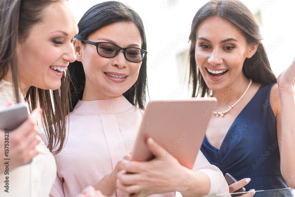 Outgoing females looking at electronic tablet Outgoing females looking at electronic tablet