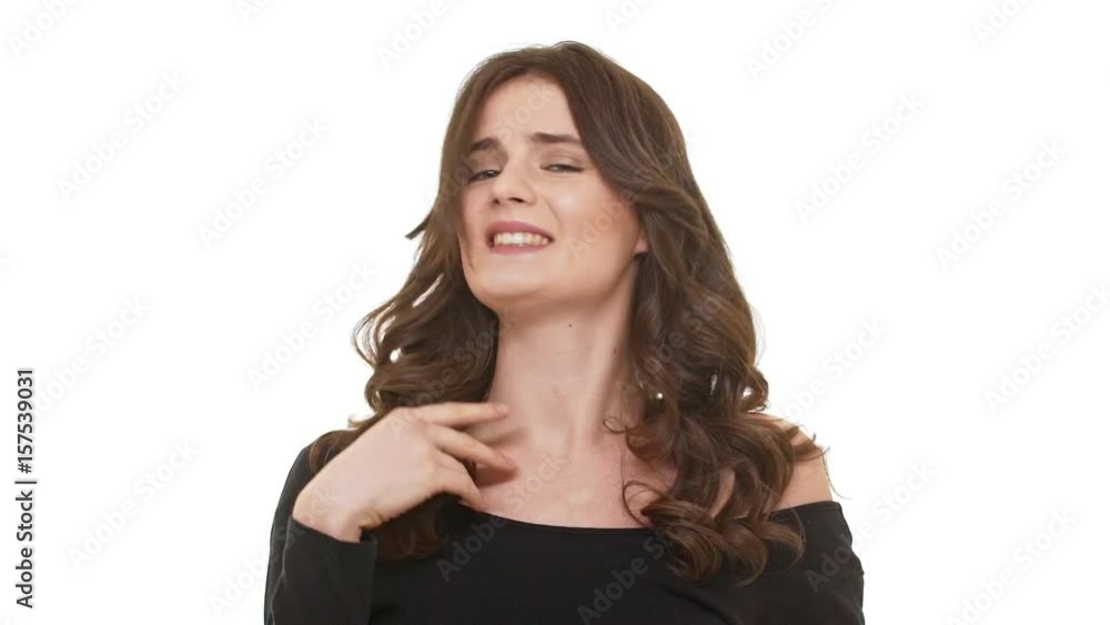 Young curvy Caucasian female with long brunette hair shoking on white background in slowmotion Young curvy Caucasian female with long brunette hair shoking on white background in slowmotion