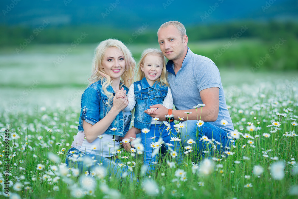 Fototapeta premium happy family having fun outdoors. Portrait of happy family in countryside Happy people outdoors wearing jeans enjoying time together