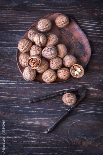 Walnuts and nutcracker on a wooden background