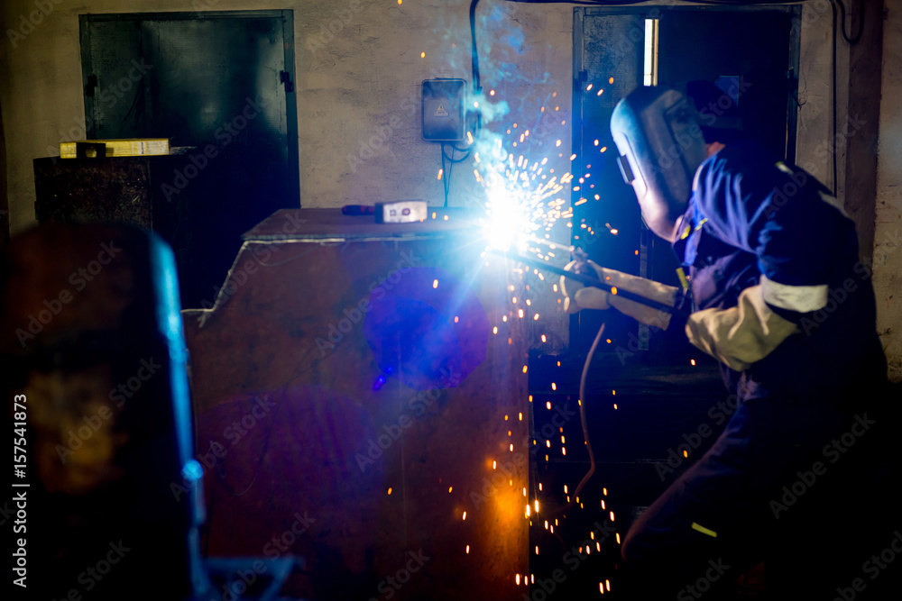 Welder at a factory Welder at a factory