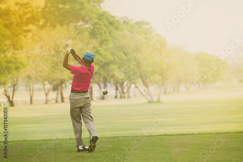Asian golfers hit sweeping and keep golf course in the summer for relax time,soft focus and blurry