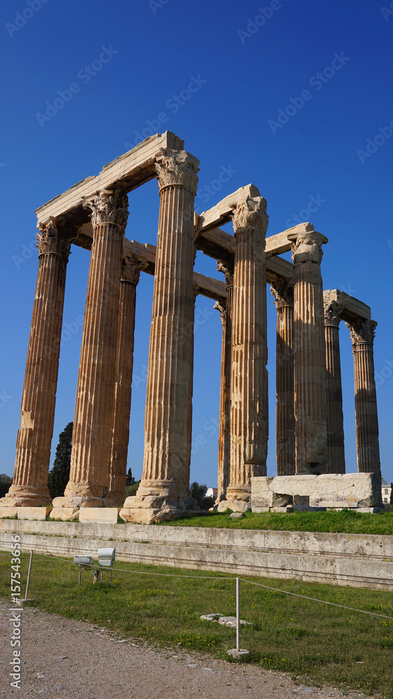 Photo of iconic pillars of Temple of Olympian Zeus with view to the Acropolis and the Parthenon, Athens historic center, Attica, Greece 