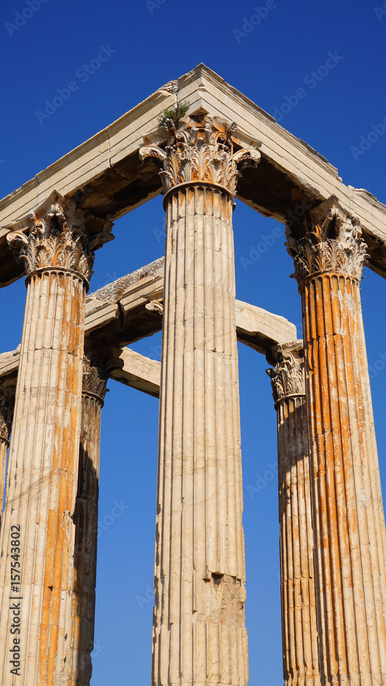 Photo of iconic pillars of Temple of Olympian Zeus with view to the Acropolis and the Parthenon, Athens historic center, Attica, Greece Photo of iconic pillars of Temple of Olympian Zeus with view to the Acropolis and the Parthenon, Athens historic center, Attica, Greece