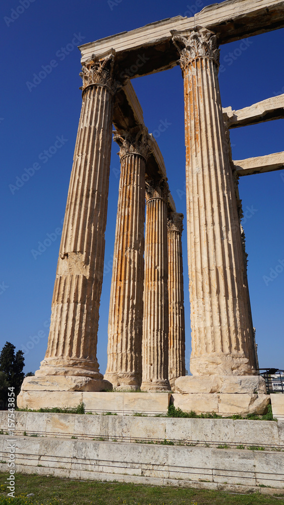 Photo of iconic pillars of Temple of Olympian Zeus with view to the Acropolis and the Parthenon, Athens historic center, Attica, Greece Photo of iconic pillars of Temple of Olympian Zeus with view to the Acropolis and the Parthenon, Athens historic center, Attica, Greece