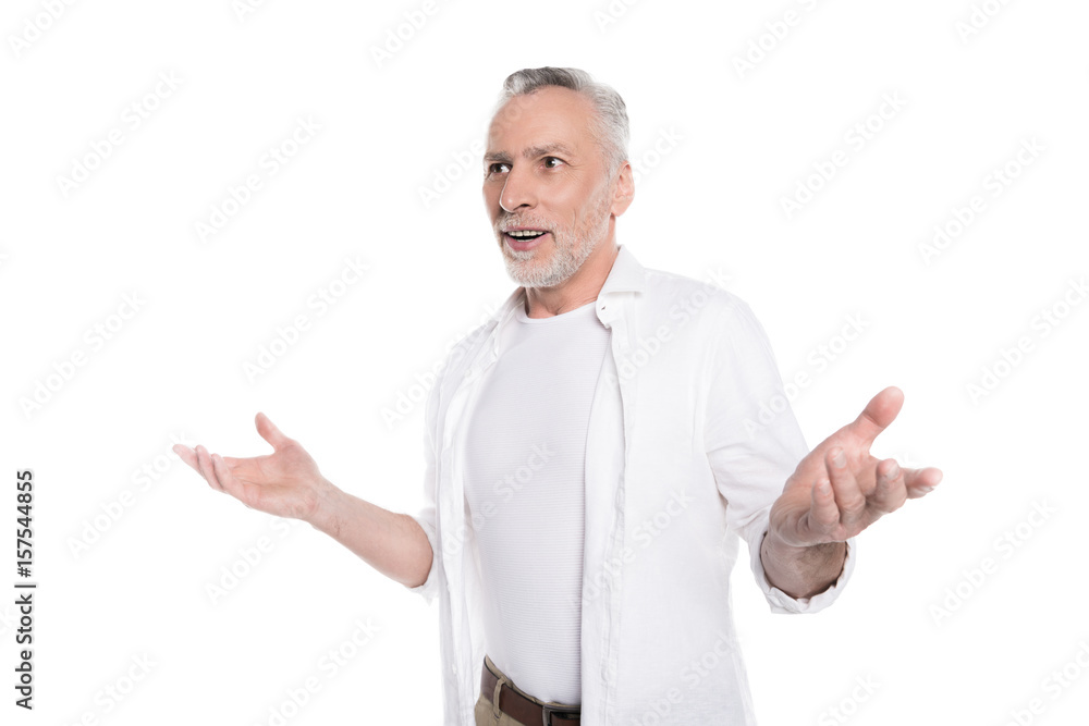 Surprised smiling mature man gesturing with open hands isolated on white Surprised smiling mature man gesturing with open hands isolated on white