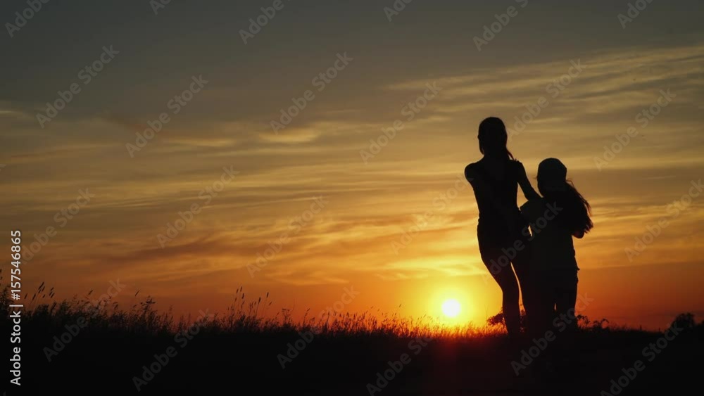 Two Friends Hold Hands And Spin In Circles In A Beautiful Summer Day At Sunset Two Friends Hold Hands And Spin In Circles In A Beautiful Summer Day At Sunset