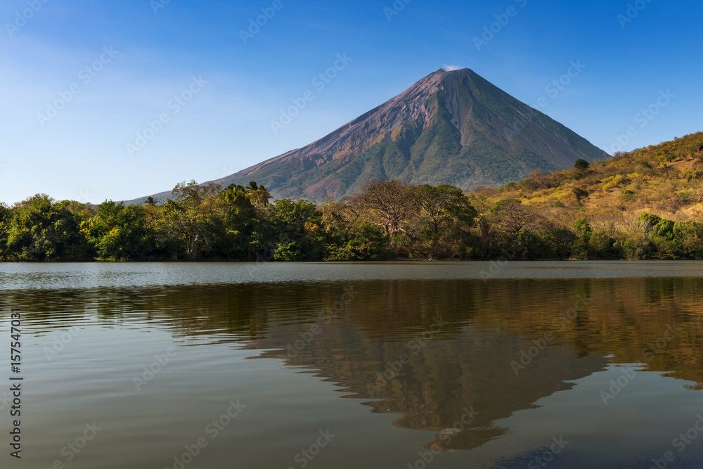 View of the Concepcion Volcano and its reflection on the water in the Ometepe Island, Nicaragua; Concept for travel in Nicaragua and Central America View of the Concepcion Volcano and its reflection on the water in the Ometepe Island, Nicaragua; Concept for travel in Nicaragua and Central America