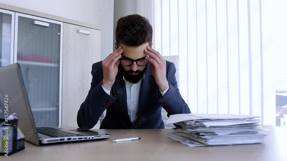 Depresed man having a headache from work problems Depresed man having a headache from work problems