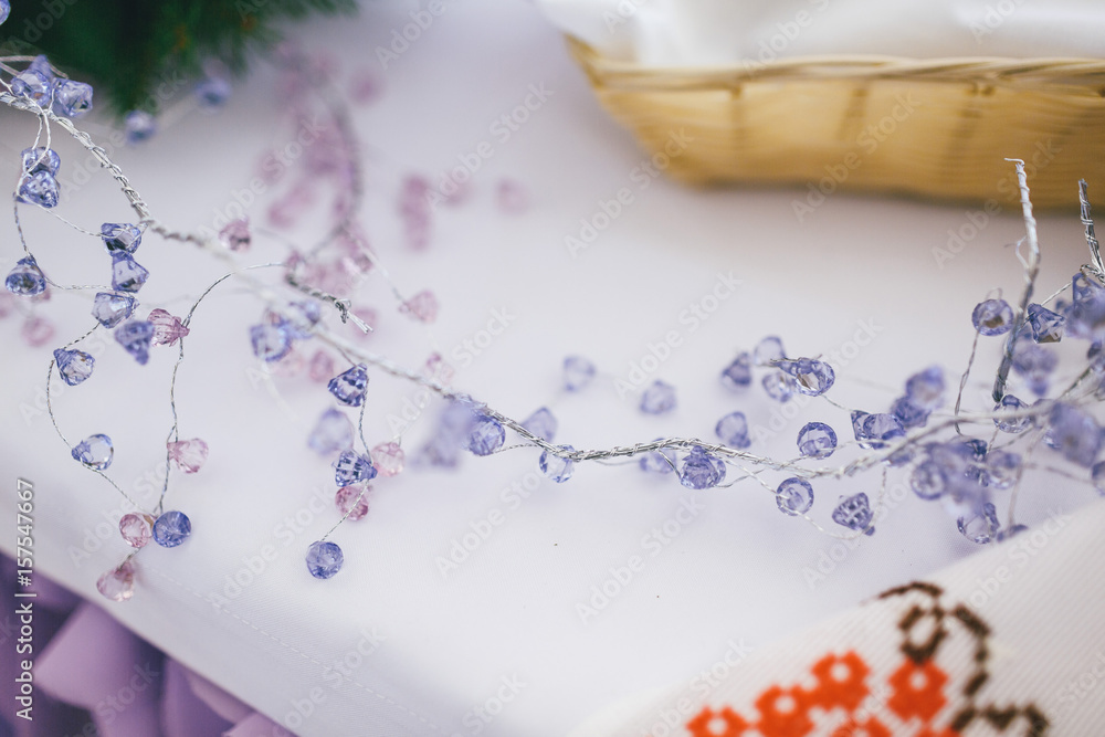 Branch of violet crystals lies on dinner table Branch of violet crystals lies on dinner table