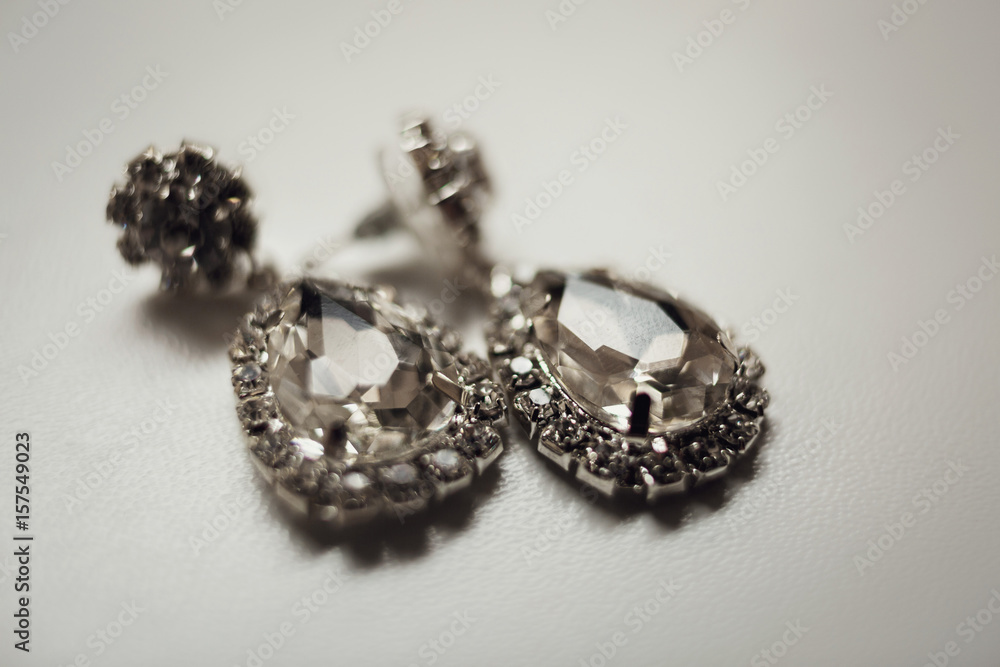 Rich crystal earrings lie on white table Rich crystal earrings lie on white table
