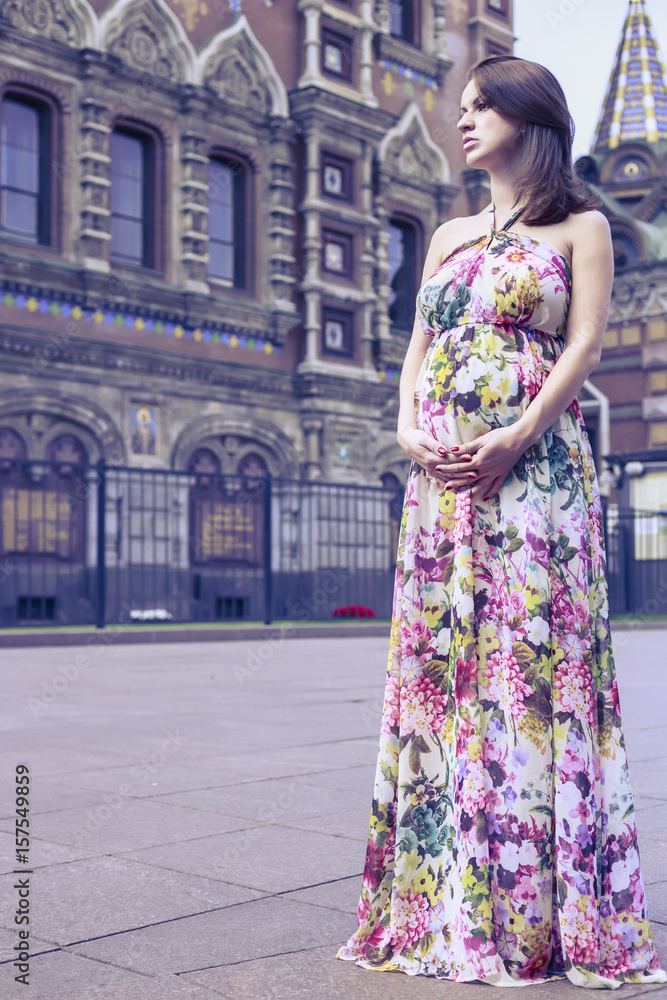 Serious pregnant woman at a beautiful temple Serious pregnant woman at a beautiful temple