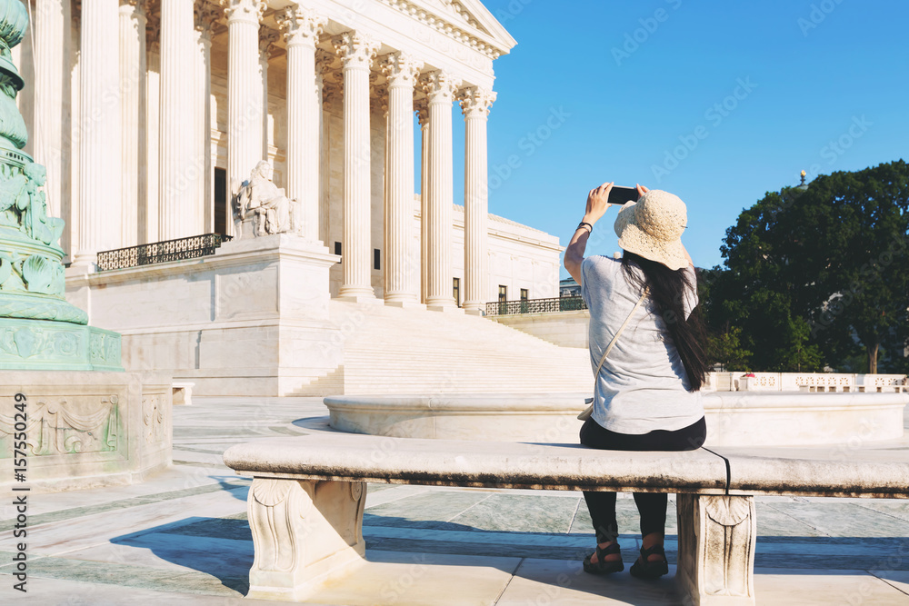 Woman taking a photo of the Supreme Court of the United States