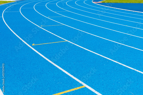 Blue Running track .Lanes of blue running track.Running track with blue asphalt and white markings in outdoor stadium.selective focus. © RobbinLee