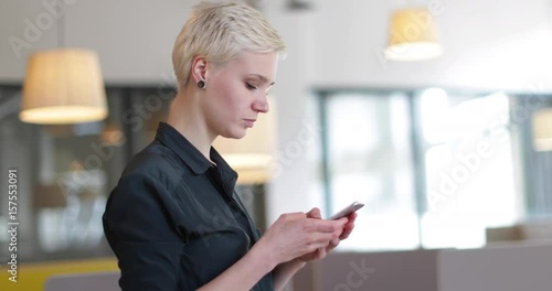 Entrepreneur using smartphone in an office photo