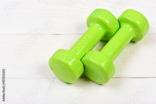 green dumbbells on white vintage with exercise concept