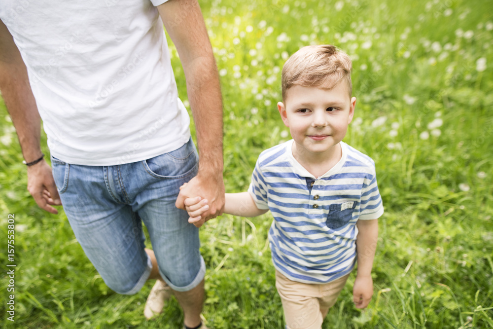 Young father with little boy, sunny spring day. Young father with little boy, sunny spring day.