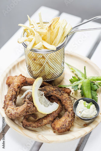 fried octpus rings calamari style with fries snack set photo