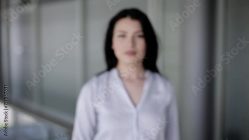Beautiful woman making touch with her hand like she's using a hologram