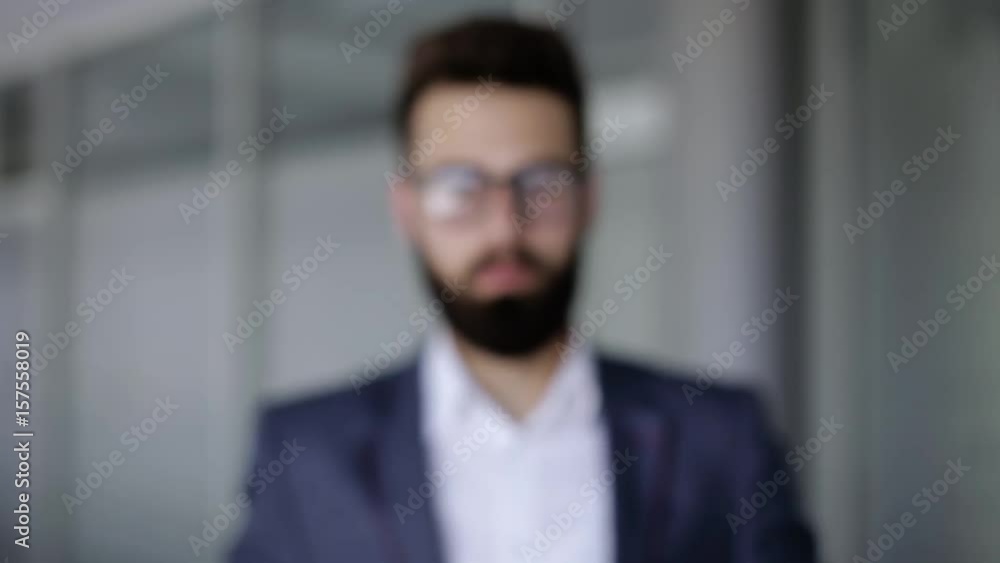 Businessman making touch with his hand like he's using a hologram Businessman making touch with his hand like he's using a hologram