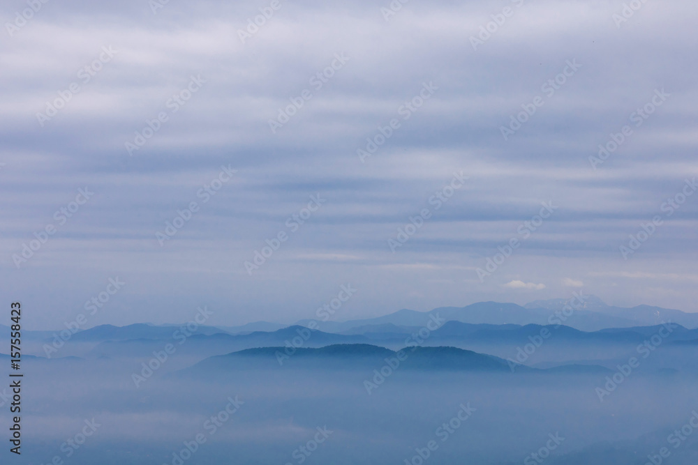 Blue mountains and sky with milky foggy and clouds Blue mountains and sky with milky foggy and clouds