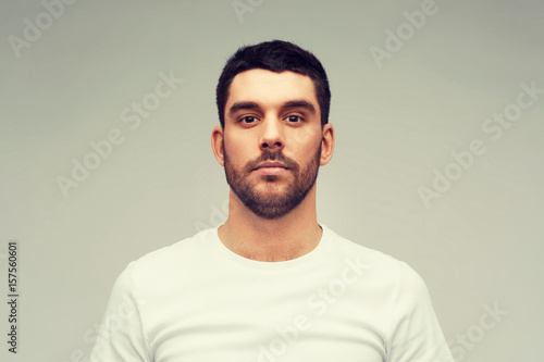 young man portrait over gray background © Syda Productions