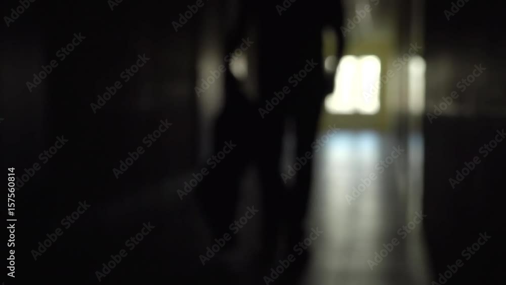 Silhouette of a man runs through the dark corridor. Dismissal.The Ghost of a businessman .The path to success. Silhouette of a man runs through the dark corridor. Dismissal.The Ghost of a businessman .The path to success.