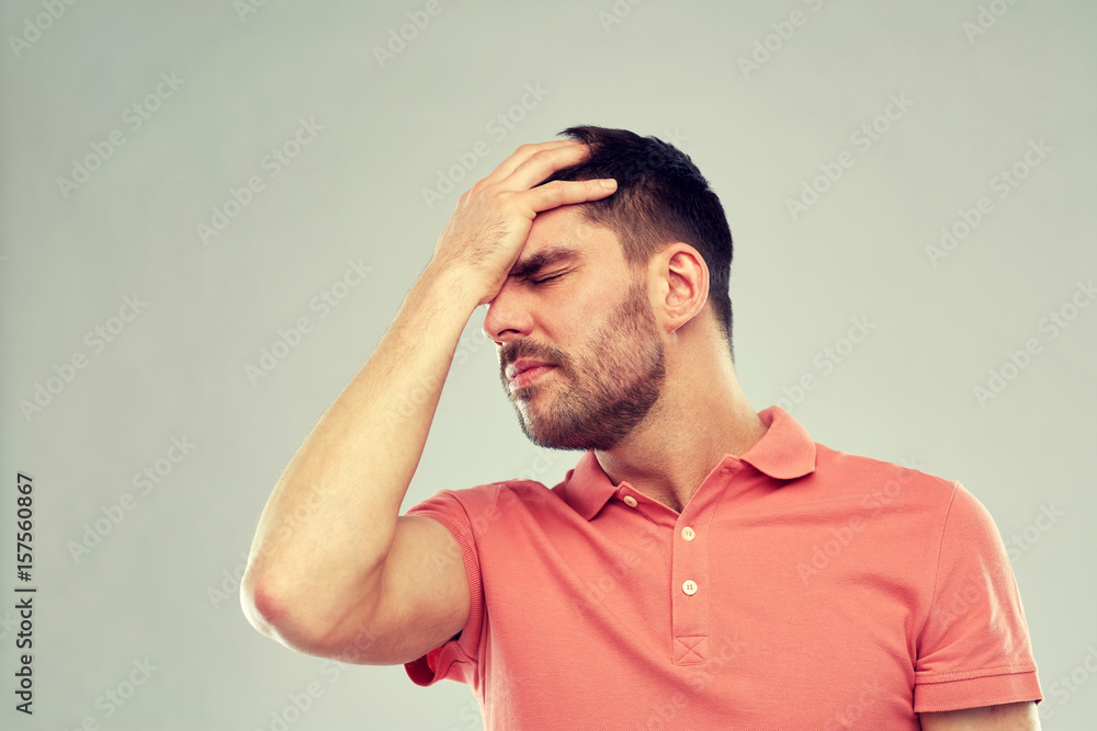 unhappy man suffering from head ache unhappy man suffering from head ache