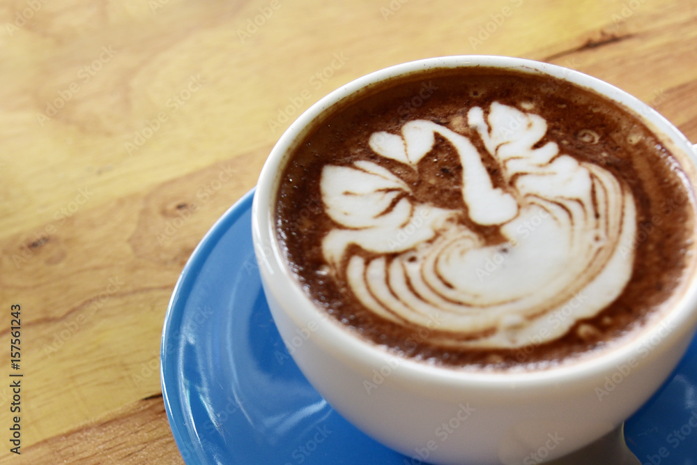 closeup cup of coffee latte art and mocha on old brown wooden background