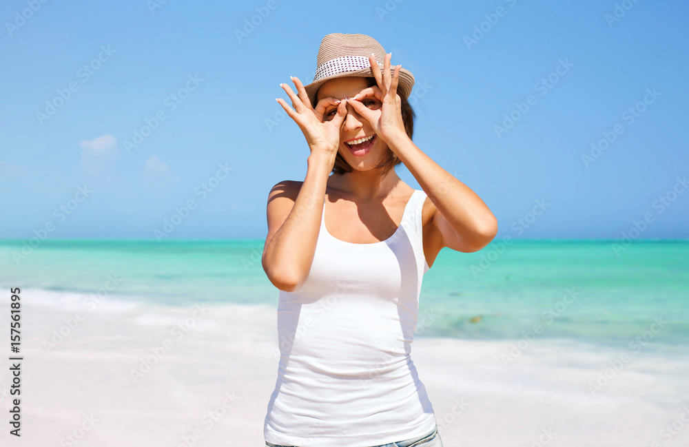 happy young woman in hat on summer beach